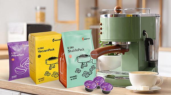 Image of four different packaging solutions for coffee storage, sitting next to a coffee machine.